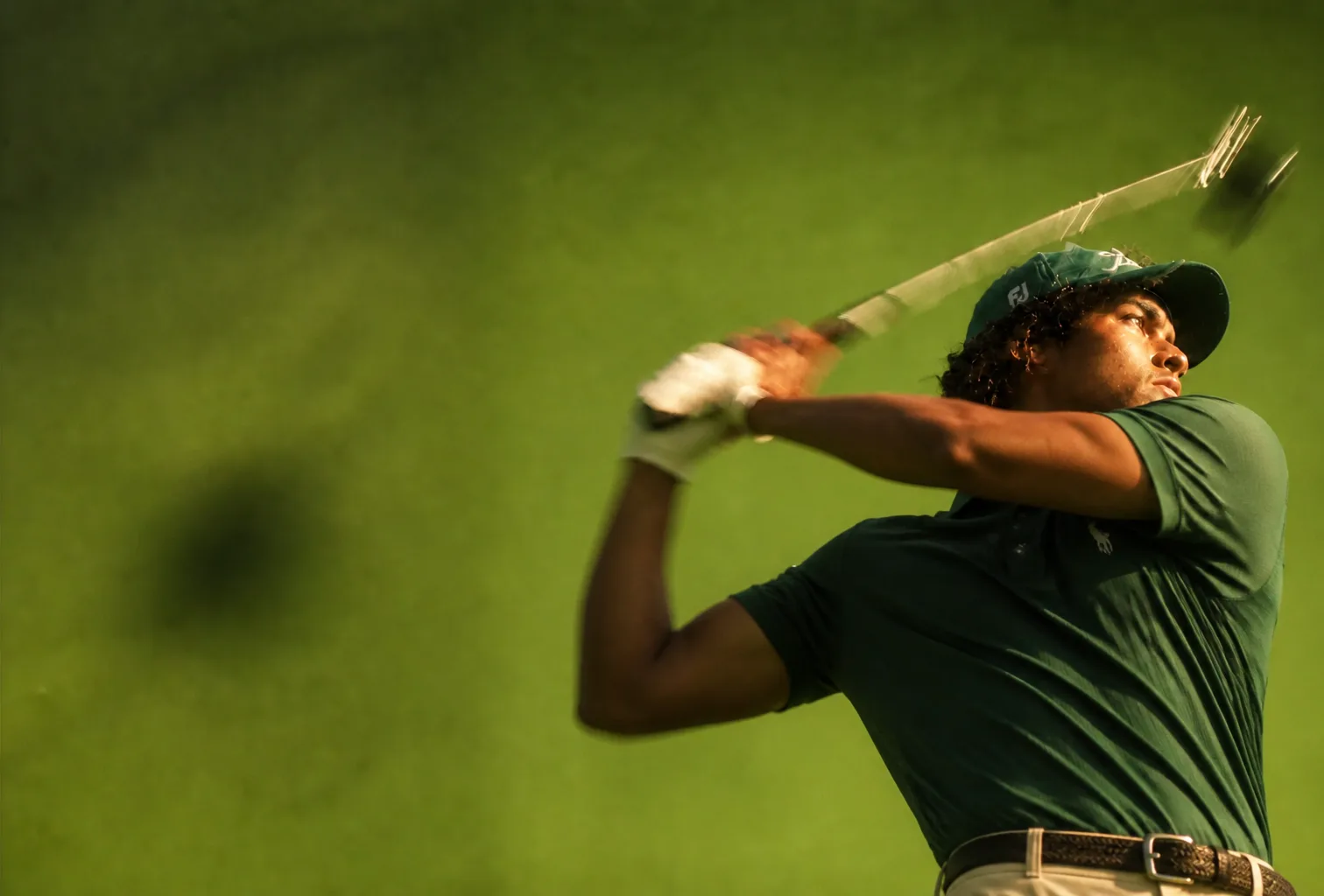 A golfer following through on a drive